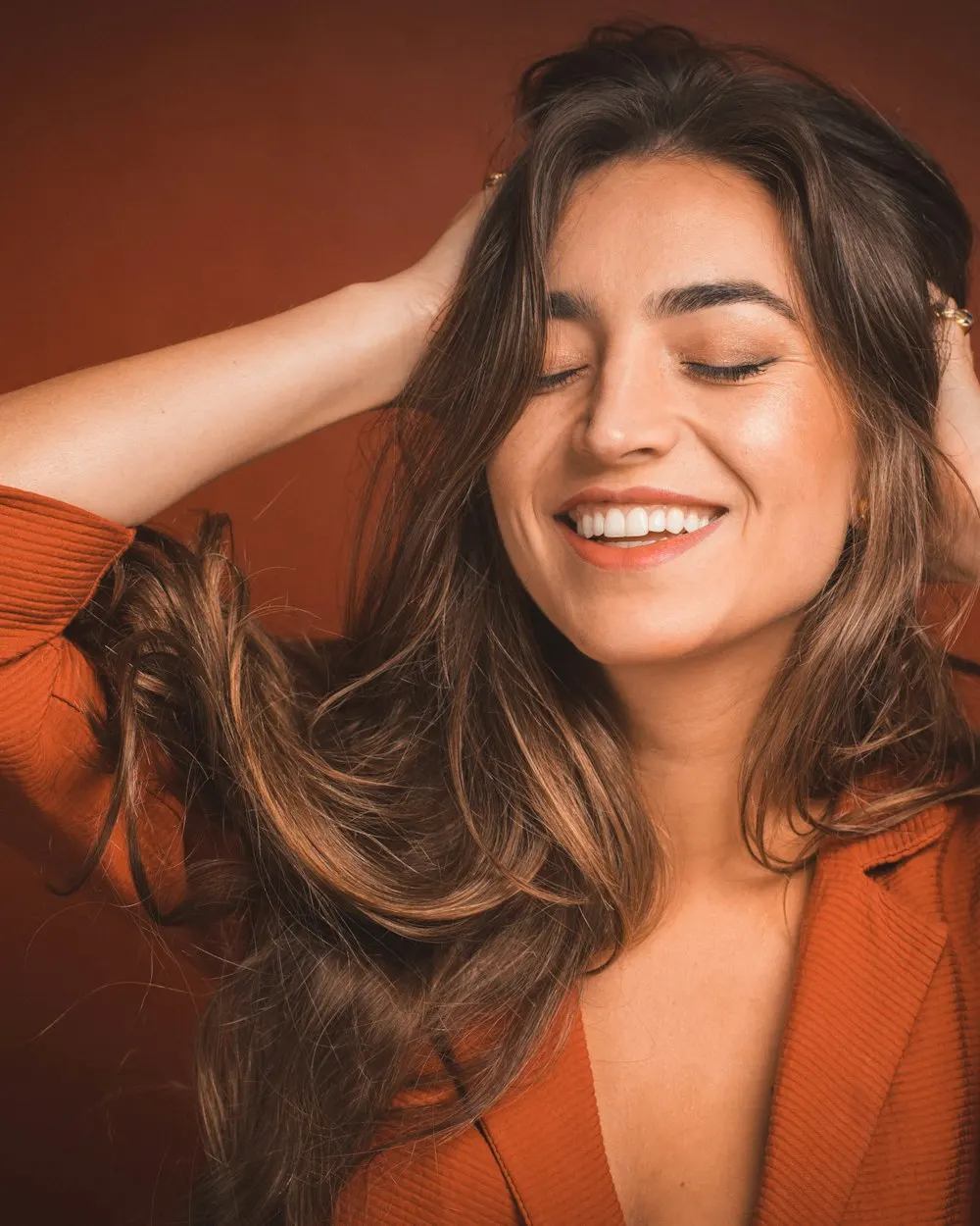 A smile and hands running through long hair